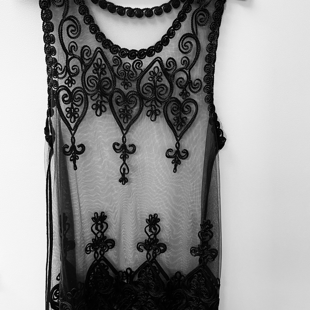 Women’s see through black lace tank top.